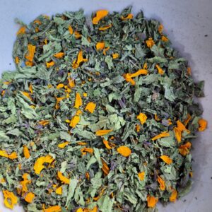 A bowl of green and orange leaves.