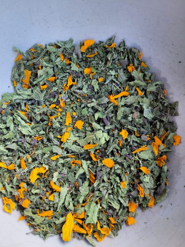 A bowl of green and orange leaves.