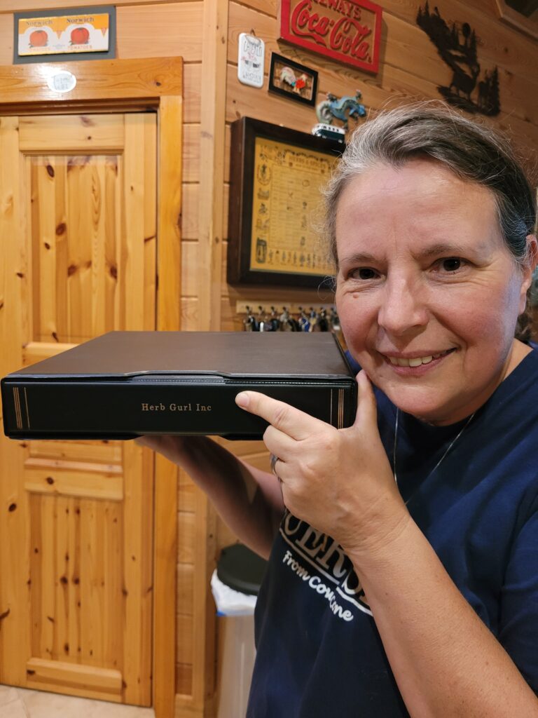 A woman holding up a dvd player in front of her face.